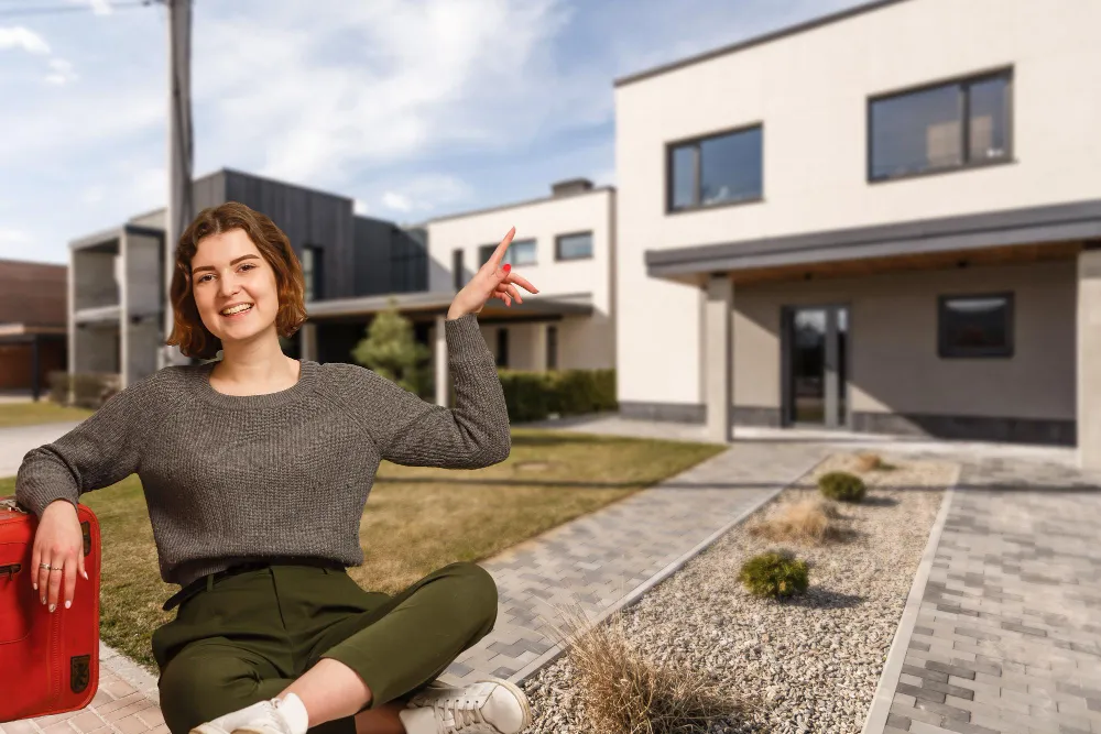 Young woman celebrating outside new home in Augustine Heights Ipswich QLD with mortgage broker Fortune9 Loans